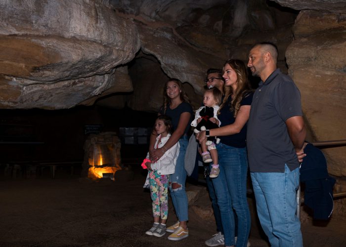 six people learning about the history of cave structures underground in Colorado Springs