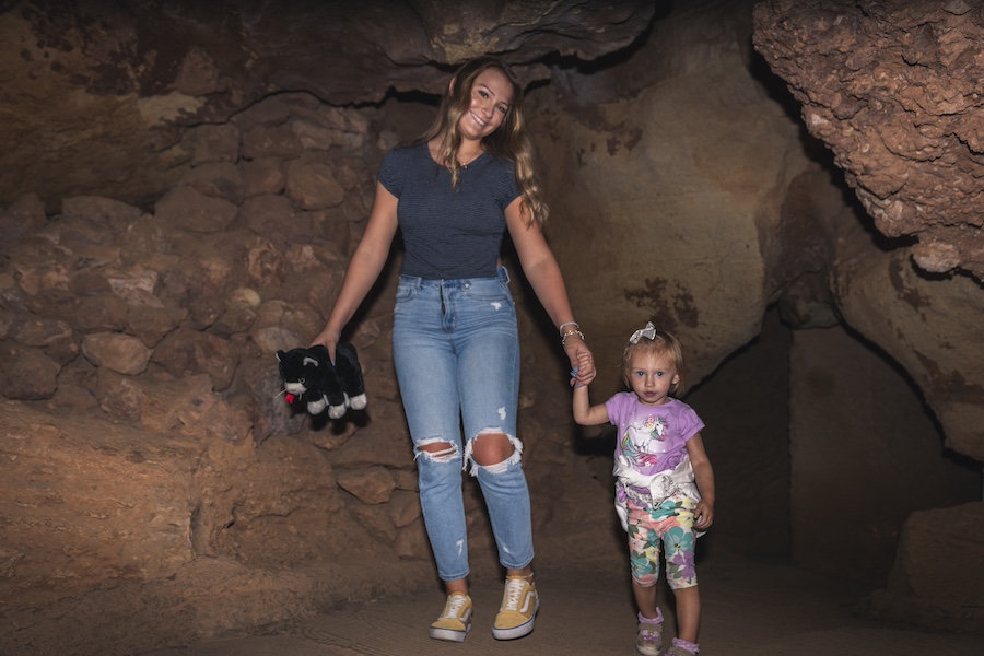 Woman and her child walk through iconic Cave of the Winds together.