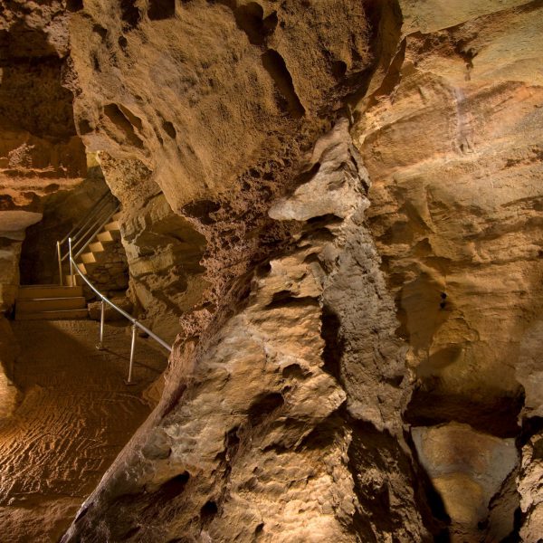 woman exploring the depths of the cave in Colorado Springs