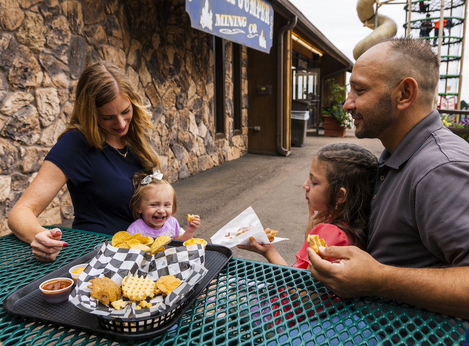 Family of three dining at Cave of The Winds for a mid-day snack.